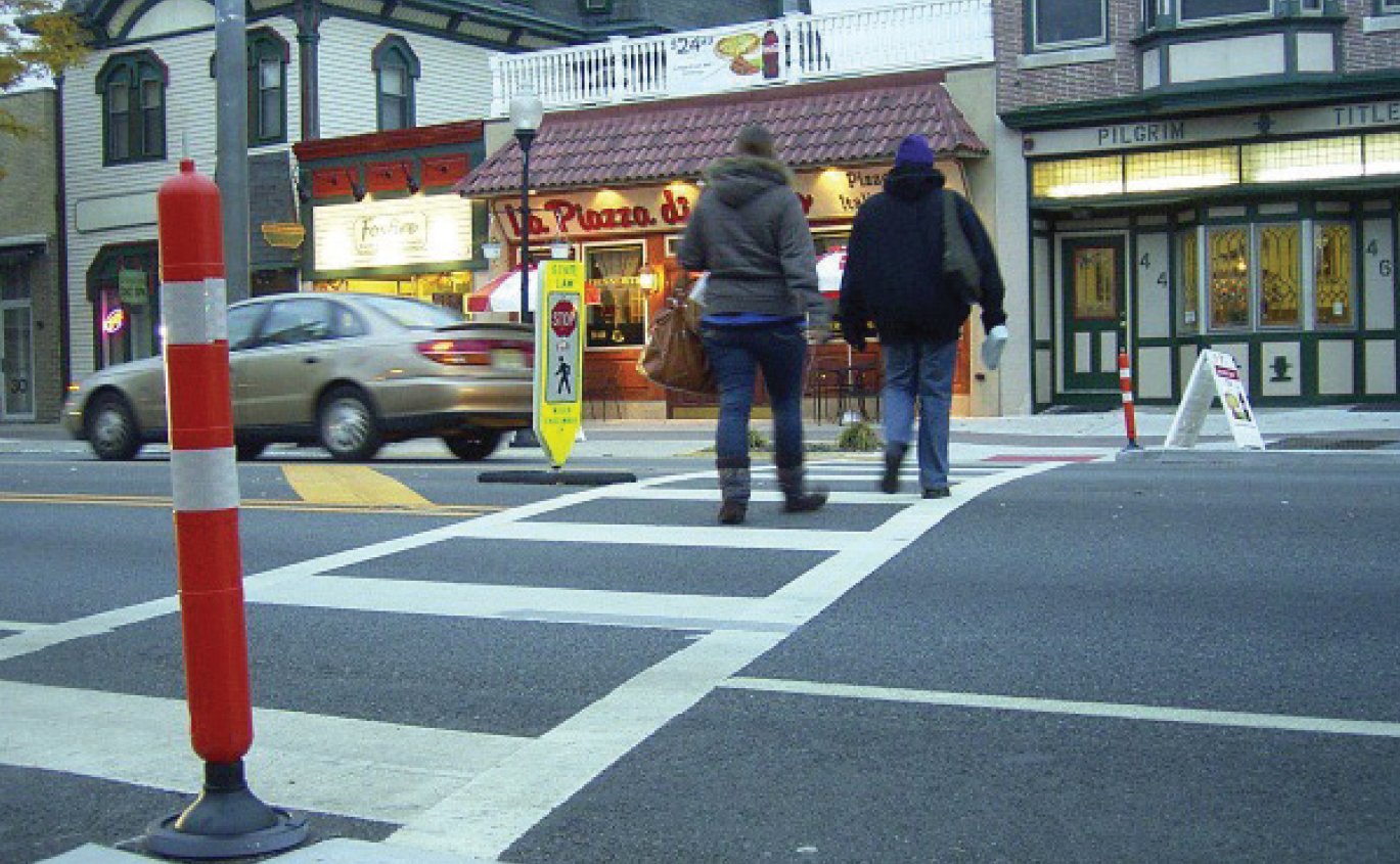 people walking across crosswalk