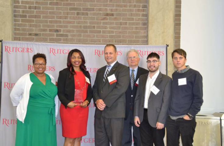 people in front of rutgers sign