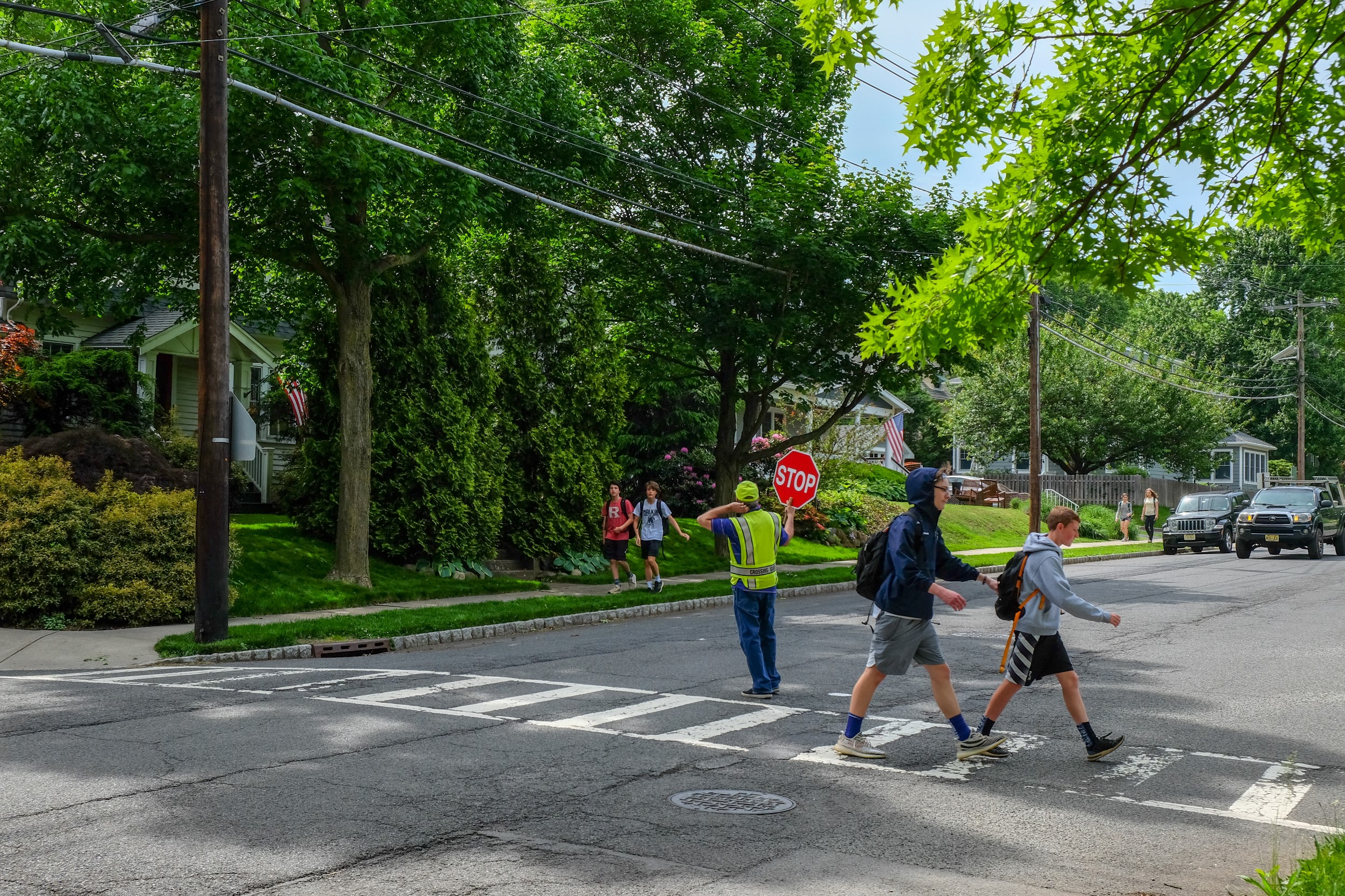 Students and crossing guard at school crossing the street.